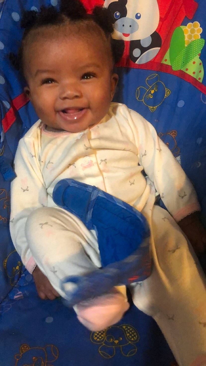 Aaniyah is registered to the contest to win money with this photo: arm, baby, cheek, child, head, joy, person, play, sitting, skin, smile, toddler