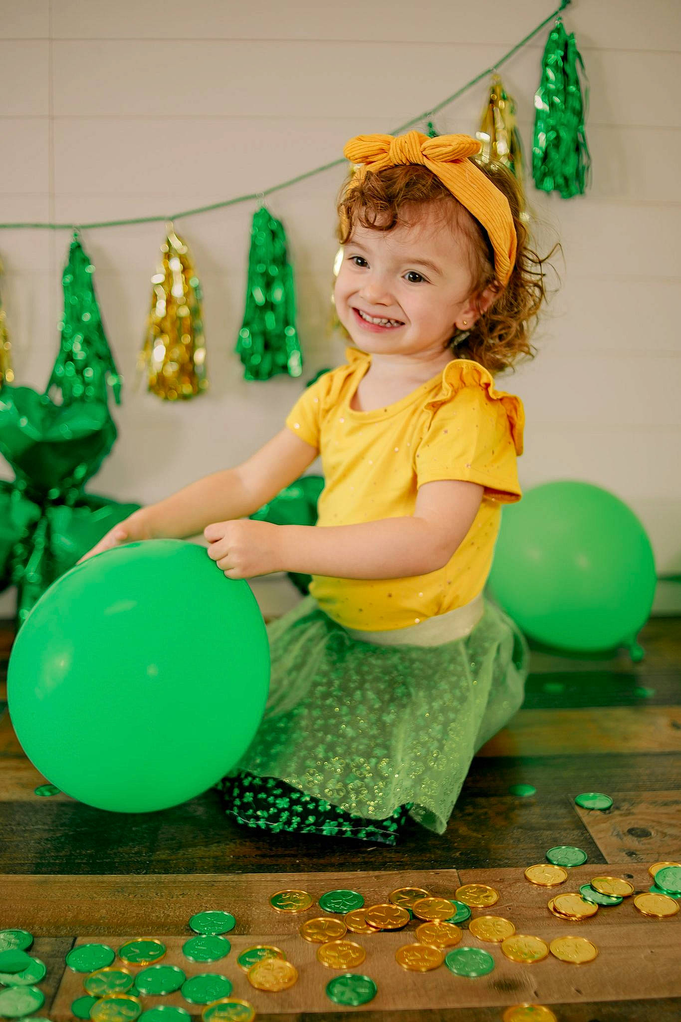 Kalani is registered to the contest to win money with this photo: baby_toddler_clothing, balloon, beauty, child, event, face, fun, green, happy, head, holiday, joy, leisure, party_supply, person, play, sitting, smile, snapshot, standing