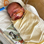 Phoenix joined the competition — help win amazing prizes! newborn, baby, hospital, blanket, swaddled, sleeping, face, nasal_cannula, oxygen_tube, medical, infant, bed, towel, cute, peaceful, animal_print, dog_illustration, healthcare, resting, person