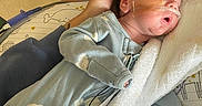Phoenix is registered to the contest to win money with this photo: newborn, baby, sleeping, hospital, medical_tube, onesie, blanket, bottle, hand, infant, person, bed, care, healthcare, cute, rest, pediatric, soft, comfort, child