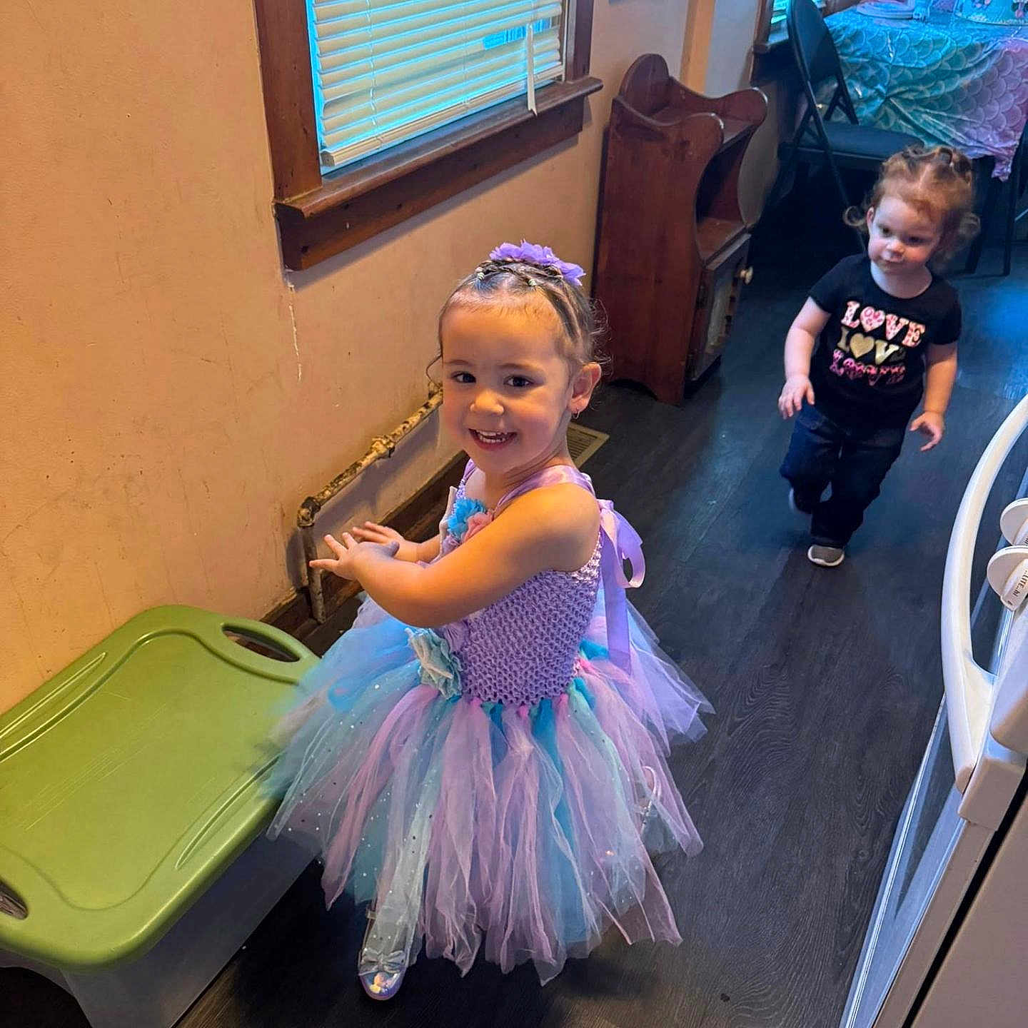 Lorelai joined the competition — help win amazing prizes! black_shirt, chair, child, clothing, dress, floor, furniture, girl, hair, happy, headband, indoor, party, person, smile, table, toddler, toy, tutu, window