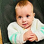 baby, infant, child, face, eyes, hands, clothing, sweater, white, mint_green, seated, babybjorn, chair, mesh, indoor, cute, portrait, expression, skin, head