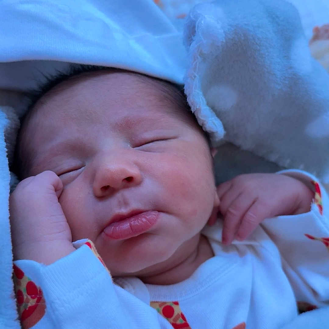 Alexi is registered to the contest to win money with this photo: architecture, baby, bed, bedroom, blanket, building, clothing, face, furniture, glove, hat, head, hospital, newborn, person, photography, portrait, quilt, sleeping, towel