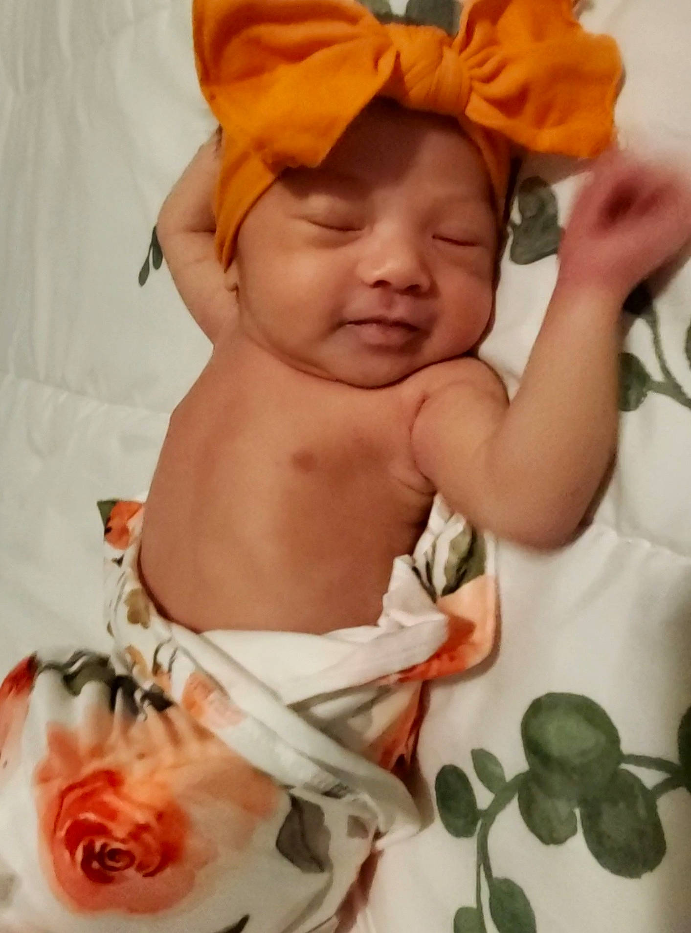 Maliyah is registered to the contest to win money with this photo: abdomen, baby, baby_toddler_clothing, cheek, chest, child, eye, hand, happy, headgear, headwear, linens, person, petal, pink, skin, smile, textile, thumb, toddler