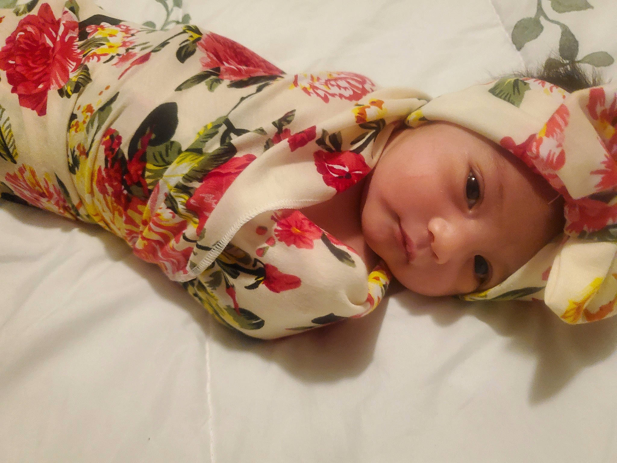 Maliyah is registered to the contest to win money with this photo: baby, baby_toddler_clothing, carmine, child, doll, fashion_accessory, headgear, headwear, linens, pattern, person, room, rose, sleeve, toddler, toy, wood