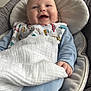 baby, baby_seat, bib, blanket, blue_clothing, car_print, child, comfort, cushion, cute, face, hand, happy, indoors, infant, portrait, sleepwear, smiling, soft_toys, young_child
