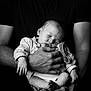 Timéo participe au concours pour gagner de l'argent avec cette photo : adult, arms, baby, black_and_white, calm, closed_eyes, face, gentle, hands, holding, infant, love, newborn, peaceful, person, portrait, resting, skin, sleeping, tshirt