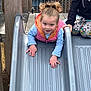 Lily Rose is registered to the contest to win money with this photo: toddler, child, slide, playground, outdoor, climbing, curly_hair, jacket, colorful_clothing, play, fun, person, fence, wood, metal_slide, patterned_pants, casual_clothing, daylight, expression, two_children