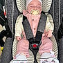 baby, car_seat, pacifier, sleeping, pink_clothing, headband, infant, stripes, safety_harness, footwear, white_shoes, child, cute, small_hands, newborn, cozy, indoors, portrait, resting, peaceful