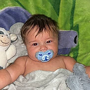 Jaxon joined the competition — help win amazing prizes! baby, blanket, pacifier, stuffed_animal, toddler, child, soft_toy, bed, cozy, indoors, sleepy, cute, face, smiling_toy, comfort, rest, lying_down, colorful_blanket, young_child, warm