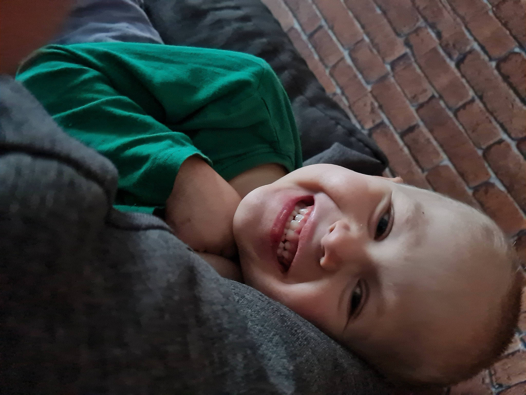 Théo participe au concours pour gagner de l'argent avec cette photo : barechested, cheek, child, comfort, flash_photography, fun, gesture, grass, happy, joy, laugh, lip, mouth, nose, person, portrait_photography, sitting, smile, toddler, wrinkle