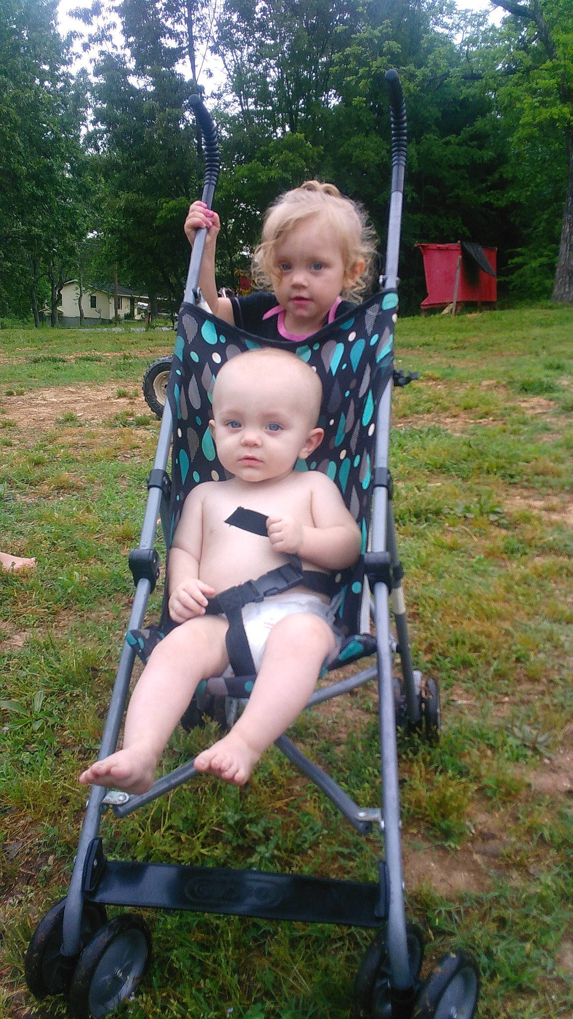 Eliza is registered to the contest to win money with this photo: baby, baby_toddler_clothing, balance, child, electric_blue, face, fun, grass, happy, head, human_settlement, leisure, nature, person, plant, recreation, sitting, swing, thumb, toddler