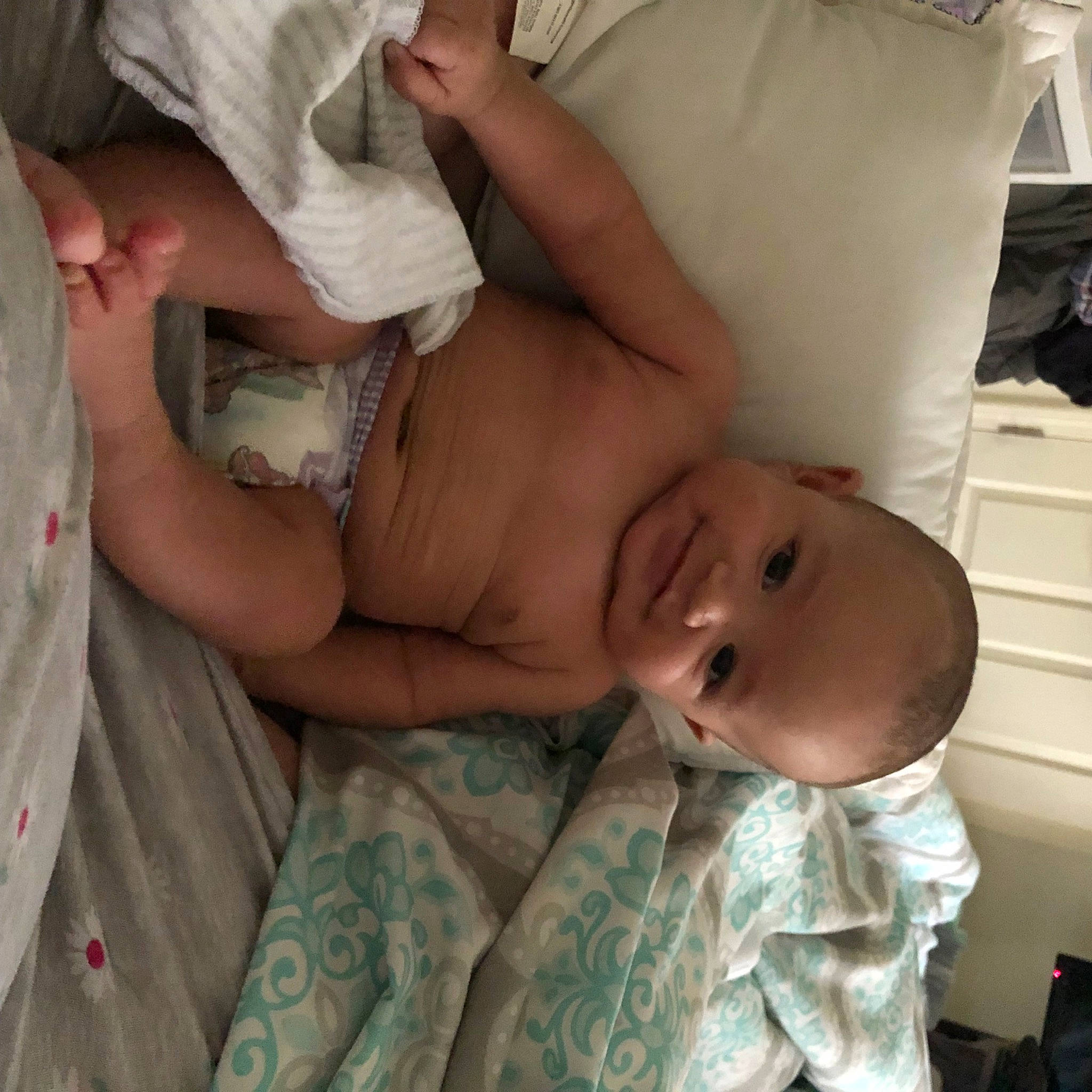 Dominick is registered to the contest to win money with this photo: abdomen, arm, baby, bed, camouflage, chest, child, comfort, eye, gesture, hand, human_body, joy, linens, military_camouflage, mouth, pattern, person, skin, textile