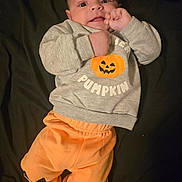 Christian joined the competition — help win amazing prizes! baby, infant, face, clothing, sweatshirt, pants, pumpkin, orange, gray, cute, lying_down, hand, expression, child, portrait, young, indoors, apparel, person, smiling
