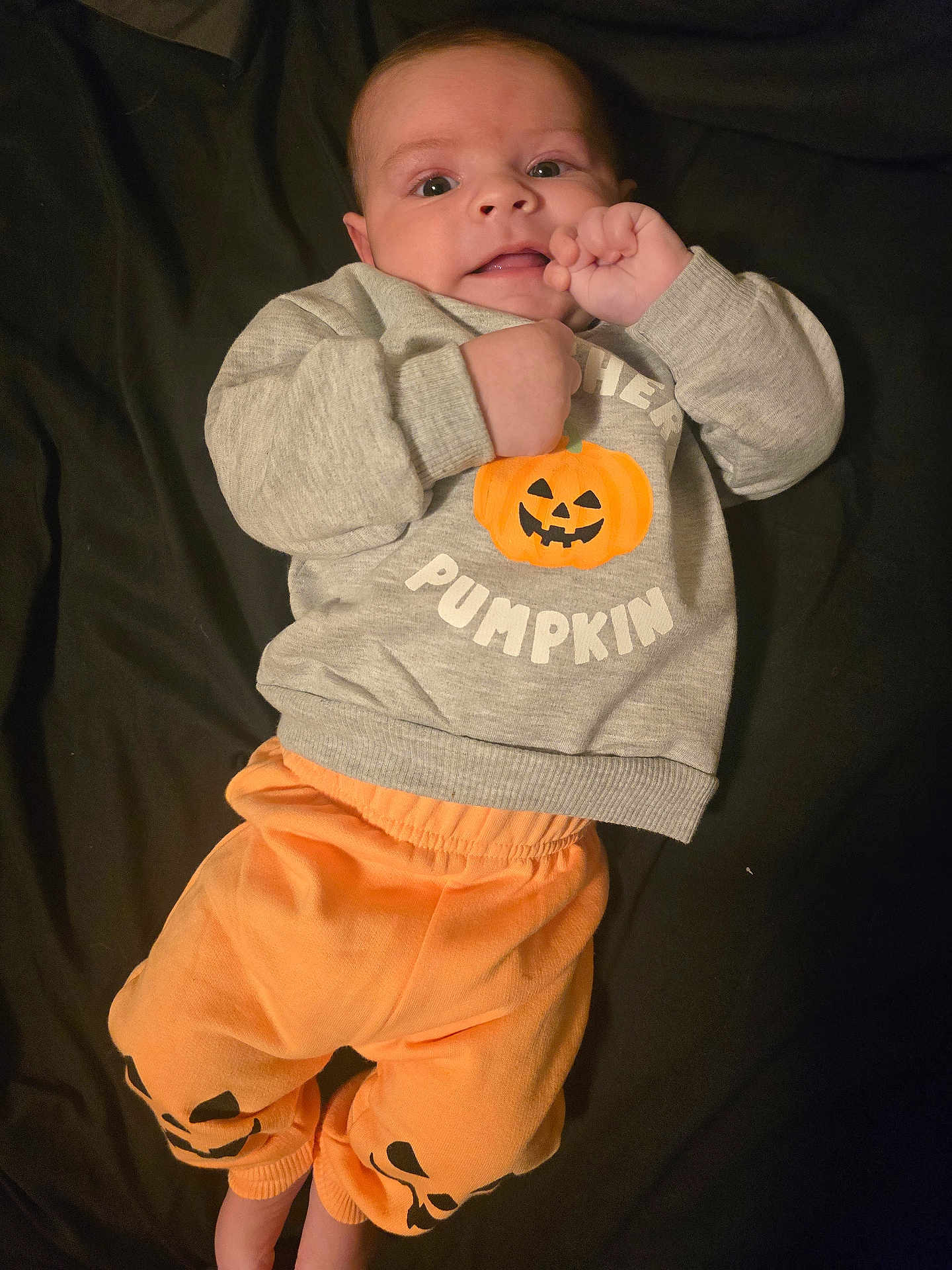 Christian joined the competition — help win amazing prizes! baby, infant, face, clothing, sweatshirt, pants, pumpkin, orange, gray, cute, lying_down, hand, expression, child, portrait, young, indoors, apparel, person, smiling