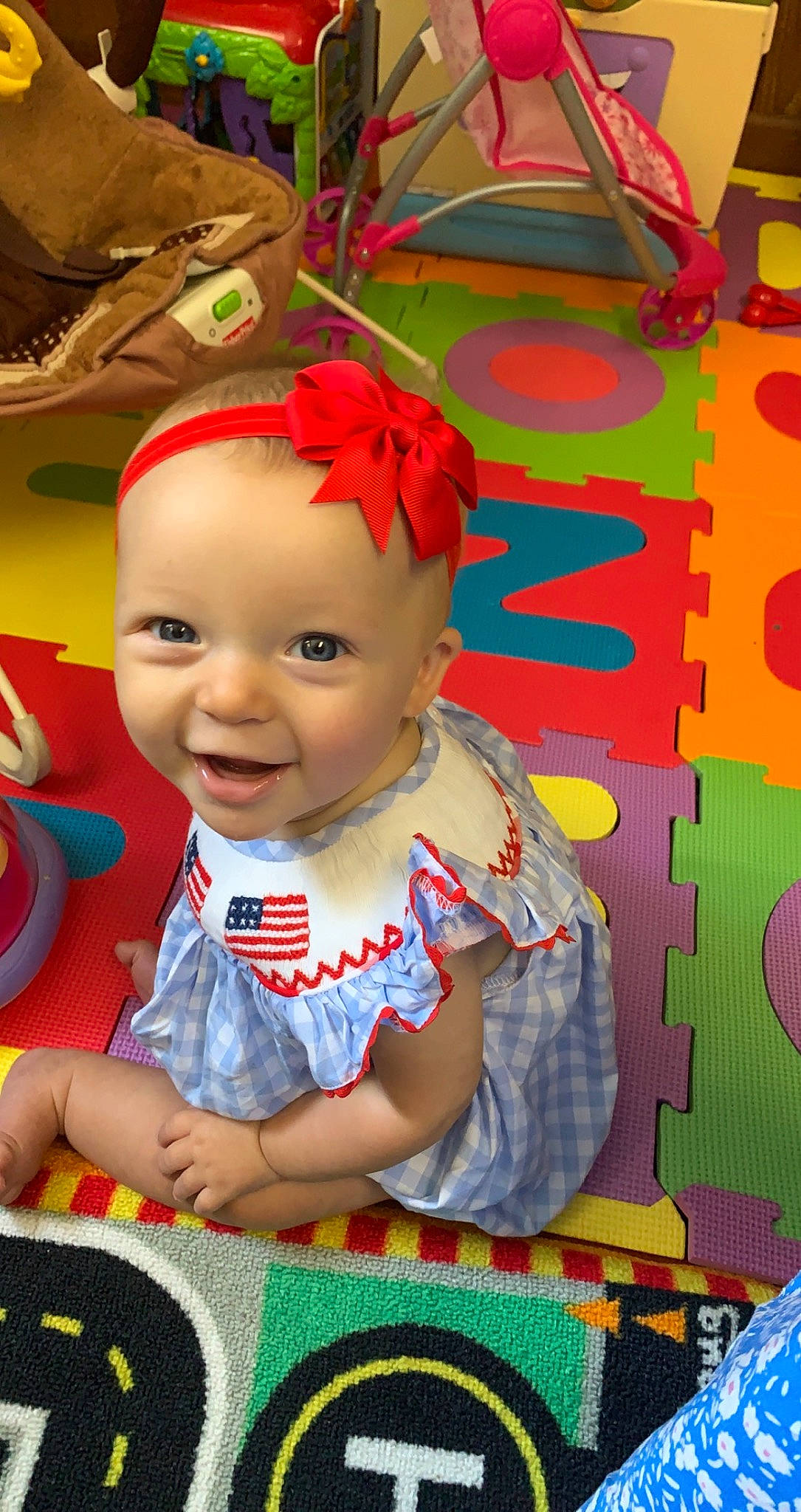 Bennett is registered to the contest to win money with this photo: baby, baby_products, baby_toddler_clothing, cheek, child, event, fashion_accessory, fictional_character, flooring, fun, happy, pattern, person, play, room, sitting, smile, snapshot, textile, toddler