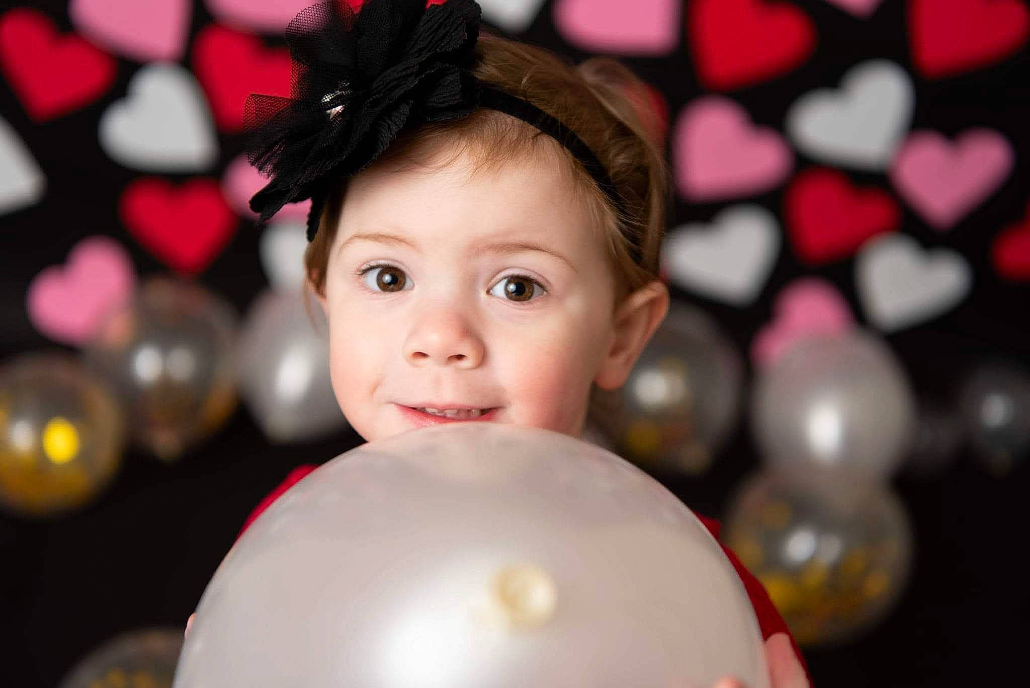 Luella joined the competition — help win amazing prizes! balloon, beauty, child, christmas_ornament, face, facial_expression, flash_photography, fun, happy, head, lighting, magenta, ornament, party_supply, people, person, pink, red, smile, toddler