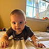baby, infant, child, portrait, smiling, curious, indoor, bedroom, bed, blanket, striped_shirt, window, stained_glass, sunlight, toy, rainbow, hands, sitting, home, photography
