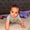 baby, infant, child, crawling, portrait, face, wide_eyes, indoor, bedroom, bed, pillow, purple_pillow, gray_shirt, short_sleeves, plush_toy, furniture, upholstery, home, photography, adorable