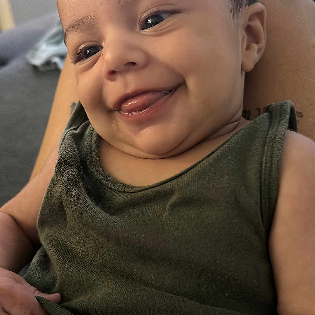 Joseph is registered to the contest to win money with this photo: baby, babylaughing, bodypart, clothing, couch, face, finger, furniture, hand, happy, head, homedecor, laughing, mouth, person, photography, portrait, smile, t_shirt, teeth