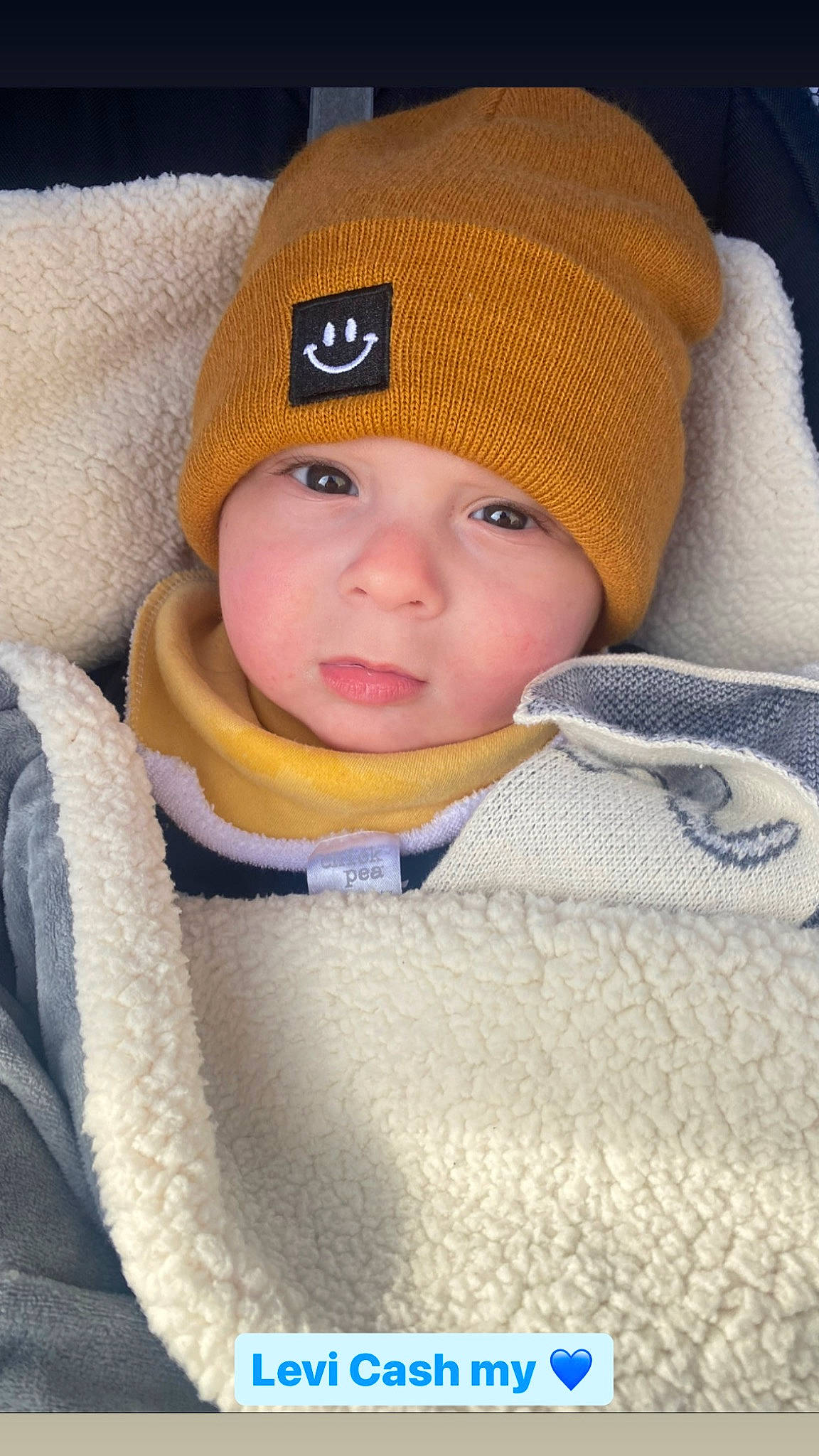 Levi is registered to the contest to win money with this photo: baby, baby_toddler_clothing, beanie, bonnet, cap, cheek, child, comfort, electric_blue, face, fashion_accessory, headwear, knit_cap, knitting, outerwear, person, portrait_photography, sleeve, toddler, winter