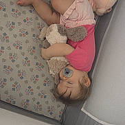Brianna joined the competition — help win amazing prizes! toddler, sleeping, crib, pacifier, plush_toy, stuffed_animal, pink_clothing, baby, child, blanket, patterned_bedding, nap, cute, indoor, soft_toy, resting, infant, peaceful, sleepwear, furniture