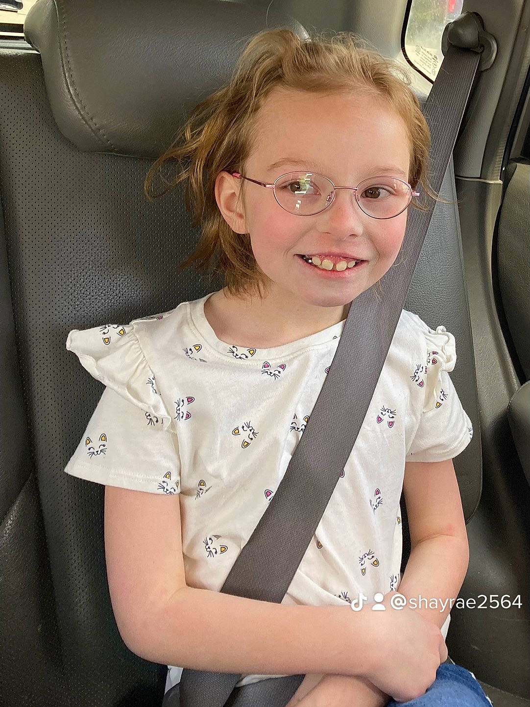 Marleigh is registered to the contest to win money with this photo: automotive_design, blond, car_seat, clothing, collar, dress, dress_shirt, eyewear, face, glasses, hair, head, joy, motor_vehicle, person, seat_belt, skin, sleeve, smile, steering_wheel