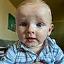 baby, baby_face, blue_eyes, casual_clothing, child, close_up, curious_expression, cute, face, hand, head, holding, human, indoor, infant, person, portrait, skin, striped_shirt, young_child