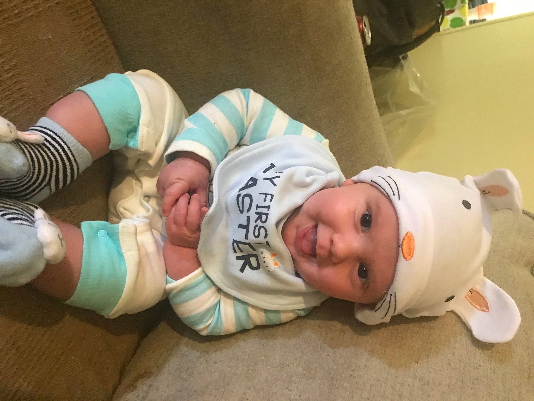 Sawyer joined the competition — help win amazing prizes! baby, baby_toddler_clothing, child, comfort, couch, elbow, eye, flooring, foot, hat, headwear, human_leg, knee, person, room, sitting, sleeve, smile, sock, sunglasses