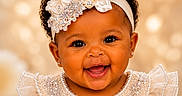 Maci is registered to the contest to win money with this photo: baby, smiling, girl, headband, pearl, crystals, dress, lace, portrait, cute, happy, child, closeup, jewelry, earrings, curly_hair, fashion, face, celebration, studio