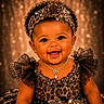Maci joined the competition — help win amazing prizes! baby, infant, smiling, dress, headband, jewelry, necklace, earrings, curly_hair, portrait, happy, sparkle, glamour, fashion, child, cute, celebration, luxury, tutu, studio