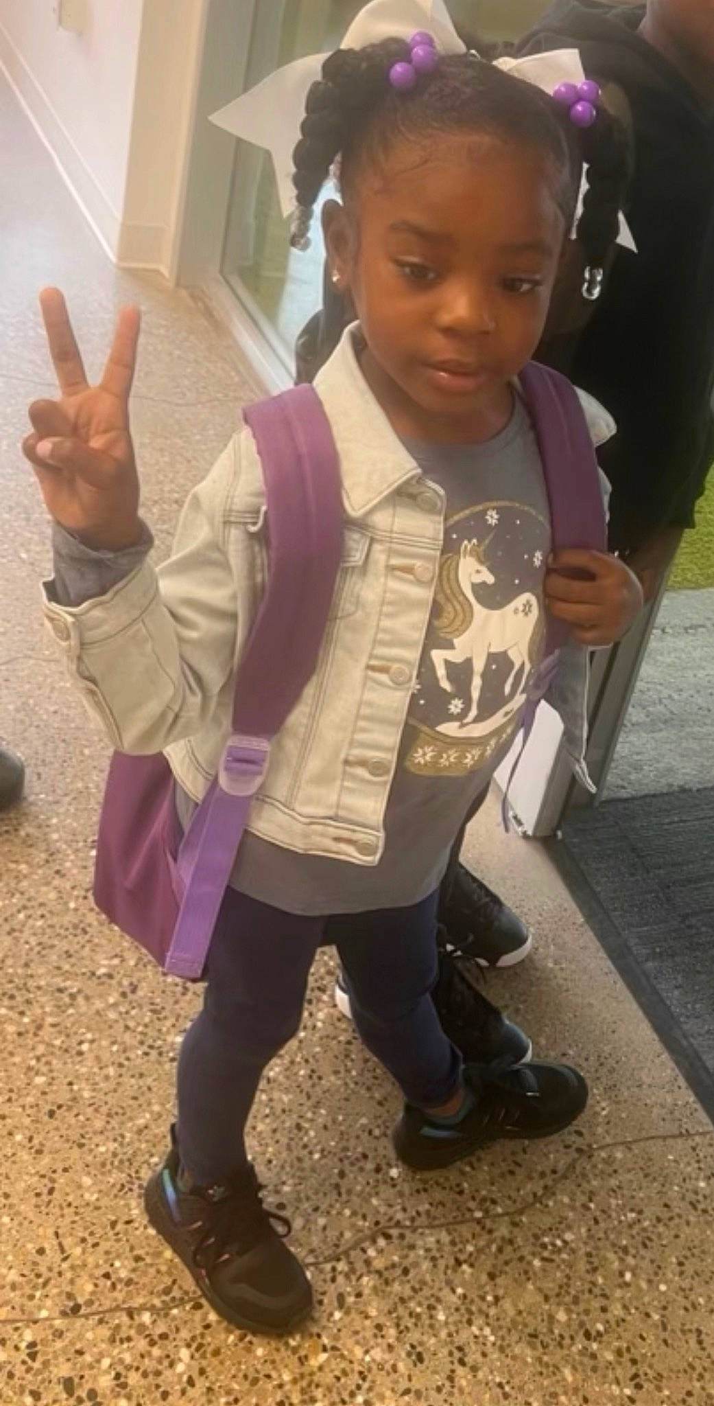 Mylan is registered to the contest to win money with this photo: child, costume, facial_expression, finger, formal_wear, fun, gesture, hairstyle, happy, jewellery, person, sleeve, t_shirt, thumb, toddler, vacation