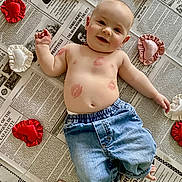 Copeland joined the competition — help win amazing prizes! baby, bare_chest, child, cute, denim_pants, floor, foot, hand, happy, head, heart_cushions, indoor, infant, kisses, lipstick_marks, lying_down, newspaper, skin, smiling, soft_toys
