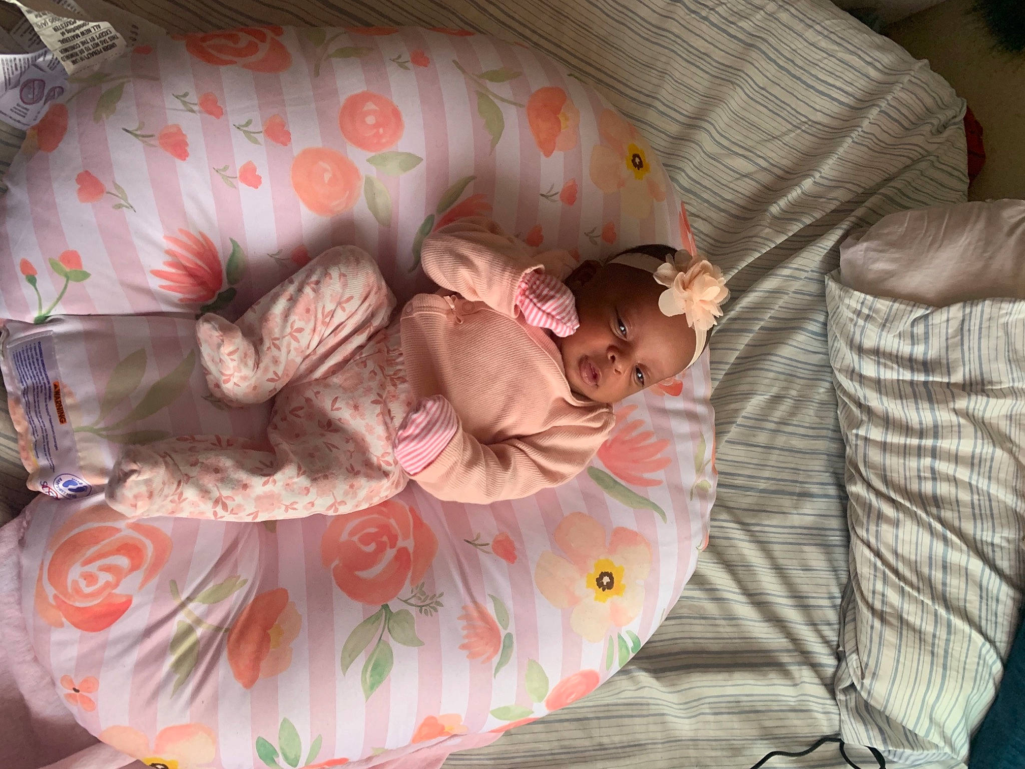 Jaylani is registered to the contest to win money with this photo: baby, baby_products, baby_toddler_clothing, bed, bed_sheet, bedding, bedtime, child, comfort, couch, cradle, infant_bed, linens, nap, pattern, person, pink, product, room, textile