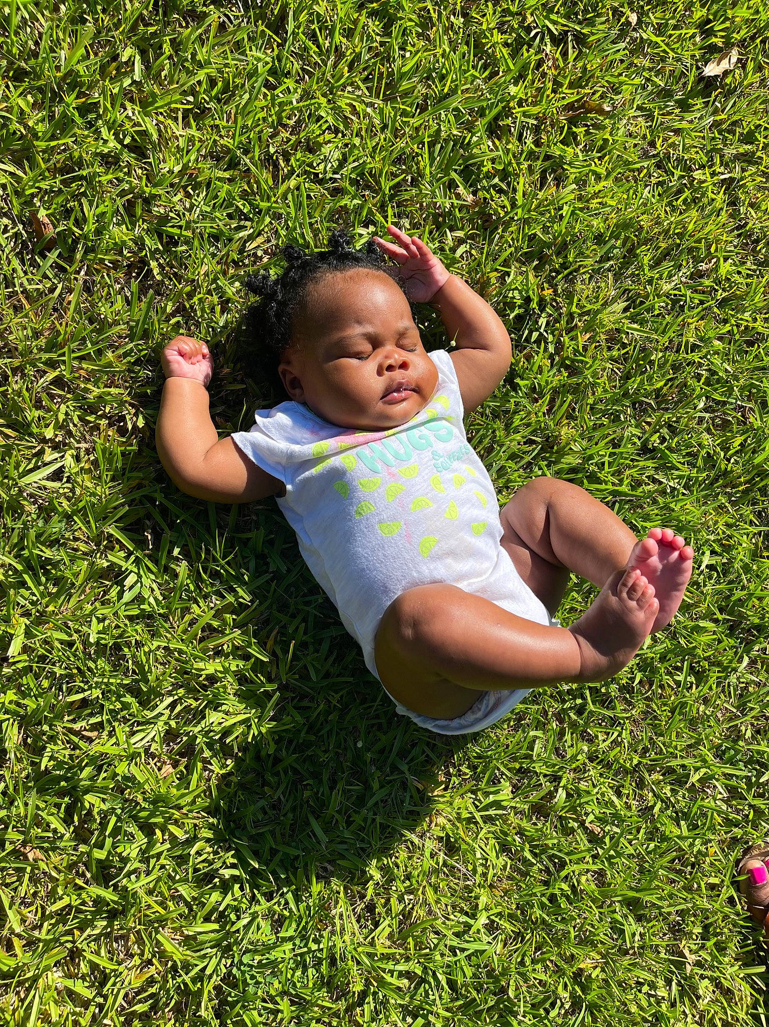Hazel is registered to the contest to win money with this photo: baby, baby_toddler_clothing, face, flash_photography, fun, grass, grass_family, grassland, groundcover, happy, lawn, leaf, leisure, meadow, natural_environment, people_in_nature, person, plant, recreation, sunlight