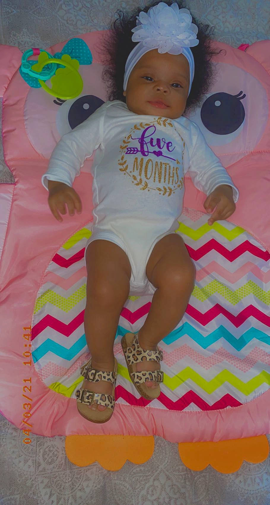 Annaliese is registered to the contest to win money with this photo: baby, baby_products, baby_toddler_clothing, child, foot, fun, happy, headwear, linens, magenta, pattern, person, pink, play, sleeve, t_shirt, textile, thigh, toddler, watch