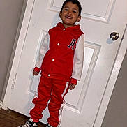 Milan Nava joined the competition — help win amazing prizes! child, boy, smiling, standing, door, red_clothing, tracksuit, sneakers, mickey_mouse, indoor, wooden_floor, white_door, casual_wear, happy, portrait, person, footwear, full_body, fashion, young