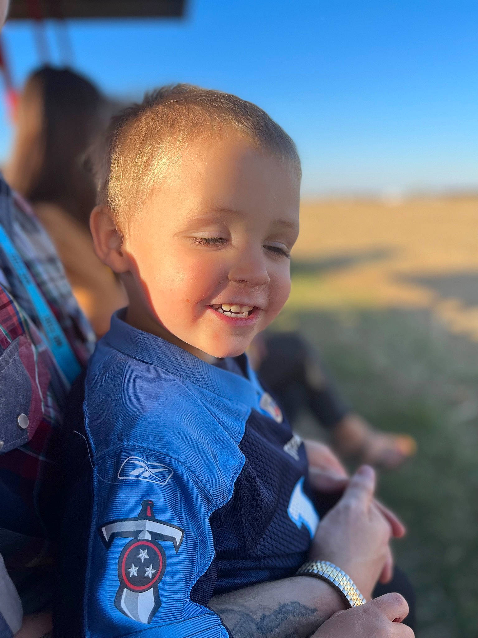 Phoenix joined the competition — help win amazing prizes! azure, child, cool, electric_blue, finger, flash_photography, fun, gesture, grass, hand, happy, joy, leisure, person, sitting, skin, sky, smile, t_shirt, thumb