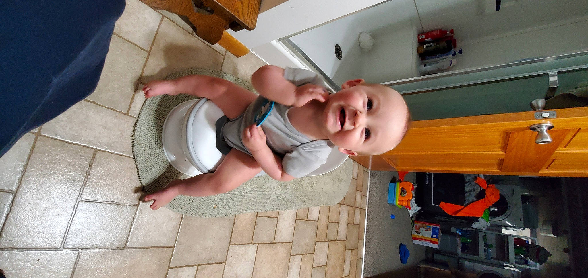 Kelton is registered to the contest to win money with this photo: baby, baby_products, baby_toddler_clothing, child, floor, flooring, fun, people, person, play, room, smile, snapshot, t_shirt, thigh, toddler, vacation, wood