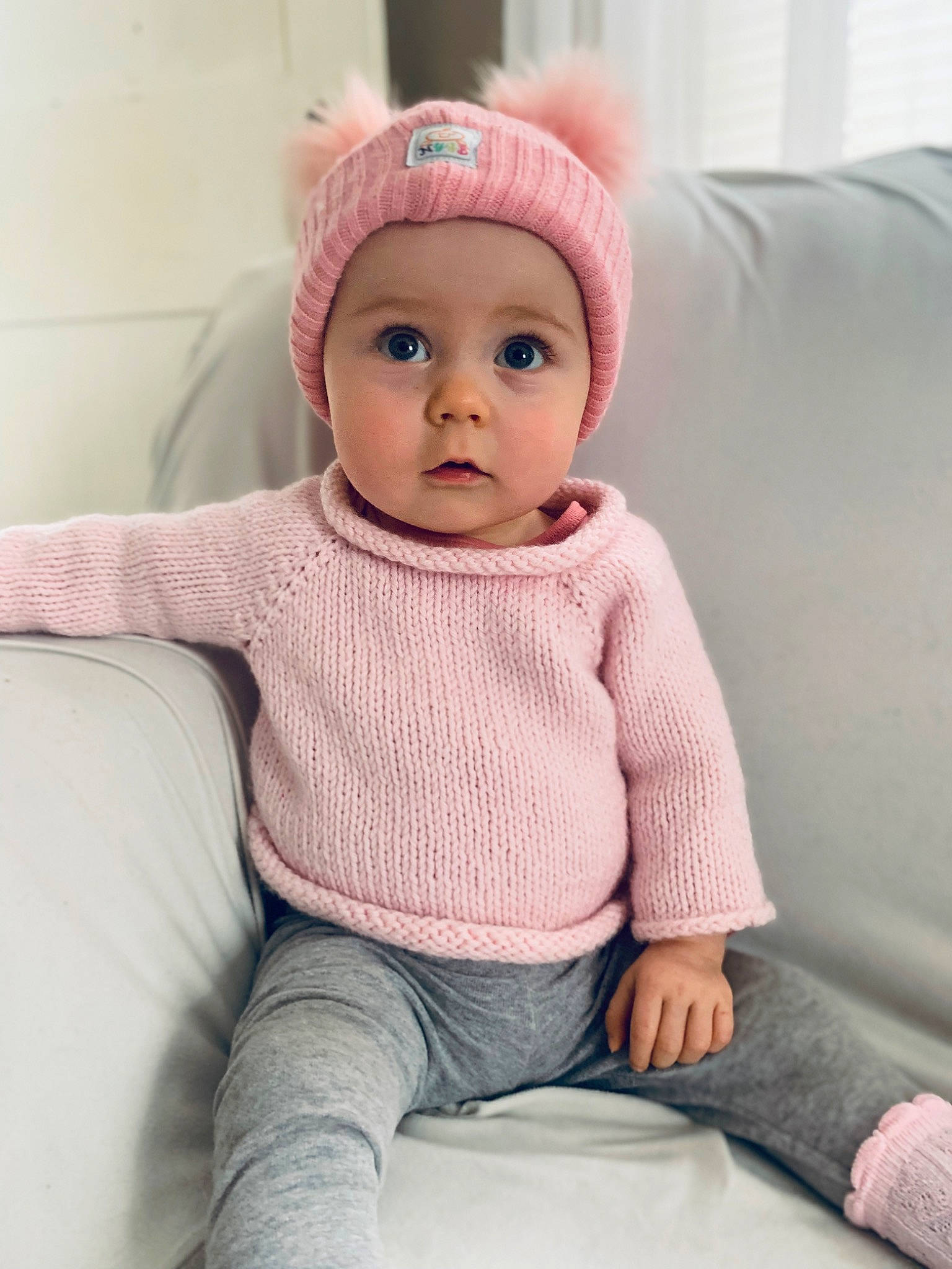 Isla Atwell joined the competition — help win amazing prizes! baby, baby_toddler_clothing, cap, cheek, child, chin, comfort, eye, face, fashion_accessory, headwear, knee, knit_cap, lip, magenta, person, pink, skin, sleeve, surprise