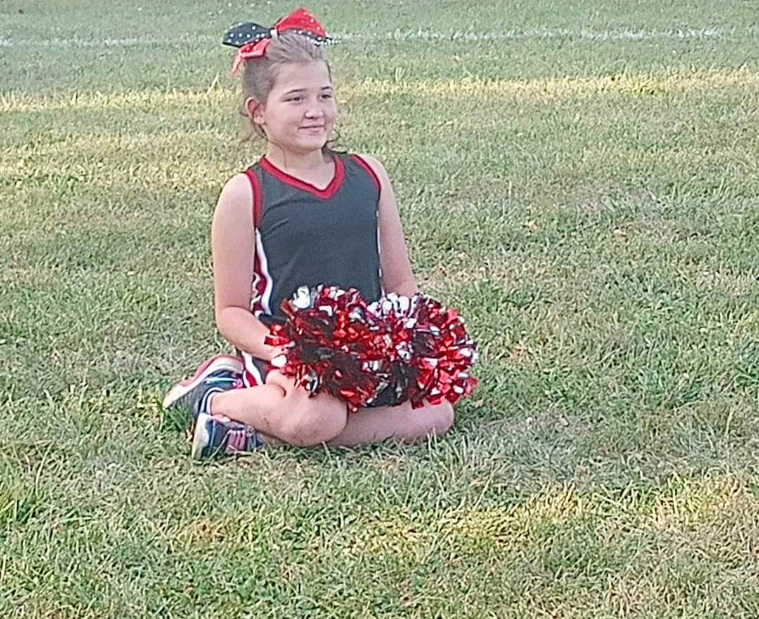 Aleigha joined the competition — help win amazing prizes! carmine, competition_event, flower, flowering_plant, fun, grass, grass_family, grassland, happy, joy, lawn, meadow, pattern, people_in_nature, person, petal, plant, player, sitting, smile