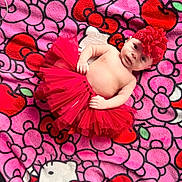 Makayla joined the competition — help win amazing prizes! baby, infant, tutu, headband, flower, blanket, hello_kitty, pink, red, cute, child, smiling, lying_down, patterned_blanket, soft, adorable, portrait, indoors, colorful, young