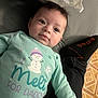 Makayla is registered to the contest to win money with this photo: baby, bed, blanket, child, clothing, cute, eyes, face, indoor, infant, lying_down, person, pillow, portrait, shirt, smile, snowman, sock, text, young