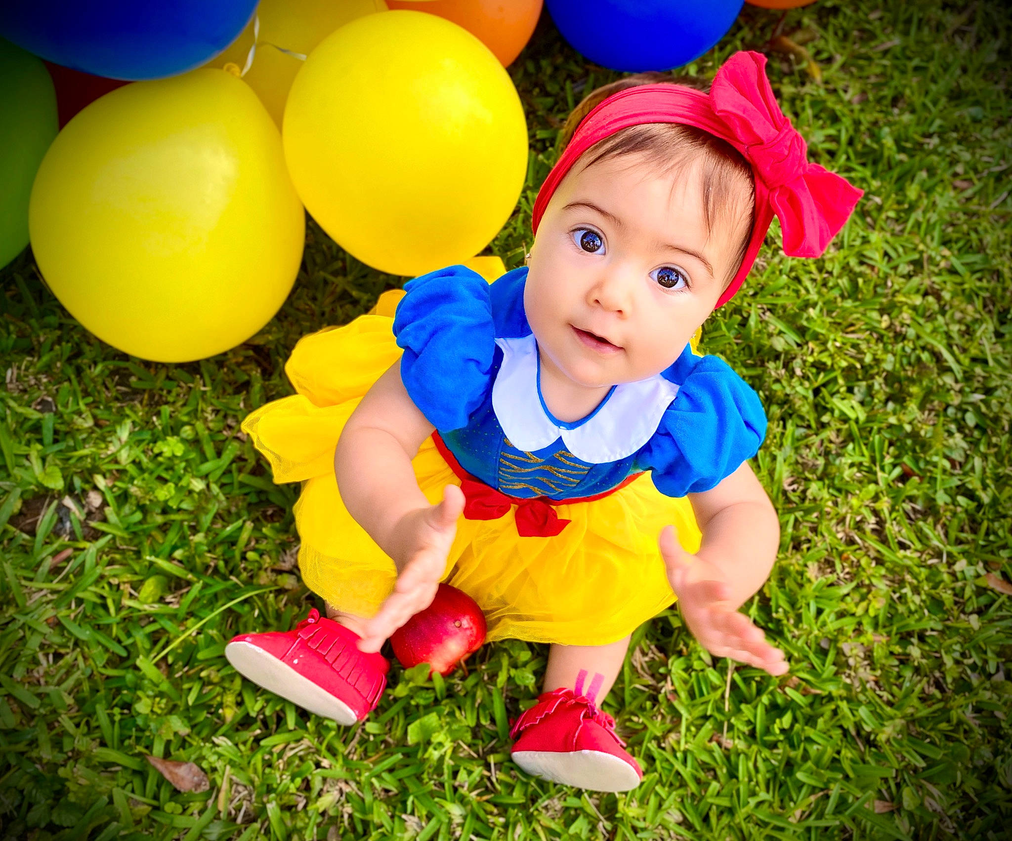 Amy is registered to the contest to win money with this photo: baby, baby_toddler_clothing, ball, balloon, child, costume, fun, grass, happy, party, party_supply, person, photography, play, playing_with_kids, smile, toddler, yellow