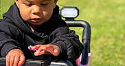 Harper joined the competition — help win amazing prizes! black_hoodie, child, childhood, curious, daylight, face, fun, green_grass, hands, hooded_clothing, nature, outdoor, play, portrait, small_vehicle, sunny, toddler, toy_car, vehicle, young_child