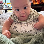 Graesyn joined the competition — help win amazing prizes! baby, infant, child, face, eyes, pillow, blanket, hand, arm, television, woman, indoor, bedroom, curious, smile, patterned, soft, cozy, home, closeup