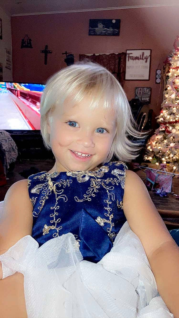 Maiya joined the competition — help win amazing prizes! baby_toddler_clothing, bangs, child, christmas_decoration, christmas_ornament, christmas_tree, electric_blue, event, fashion_accessory, fun, hairstyle, happy, hime_cut, iris, joy, ornament, person, room, sitting, smile