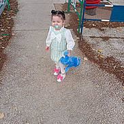Dilara a rejoint le concours — aidez-le/la à gagner de superbes lots ! child, toddler, pacifier, stuffed_toy, blue_elephant, hair_buns, dress, white_tights, pink_shoes, pavement, fence, leaves, outdoor, playground, toy, person, young_child, cute, walking, daylight