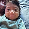 Samuel is registered to the contest to win money with this photo: baby, child, smile, face, person, adult, closeup, portrait, indoor, bed, pillow, clothing, hair, skin, happy, family, lying_down, casual, toddler, candid