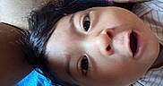 Samuel joined the competition — help win amazing prizes! baby, face, child, curious, closeup, lying_down, blanket, blue_background, skin, hair, wide_eyes, mouth_open, infant, portrait, indoors, soft_lighting, expression, person, young_child, casual